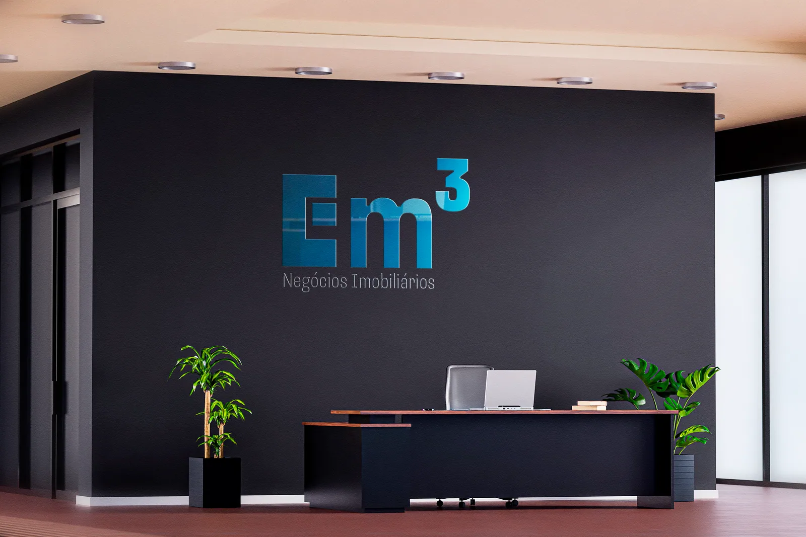 Logo da Em3 Negócios Imobiliários aplicada na recepção do escritório.